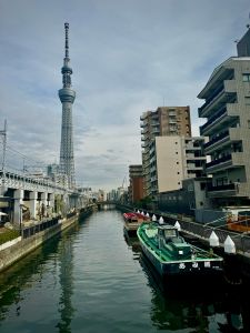 Tokyo waterways with a small boat and Tokyo Skytree in the background
