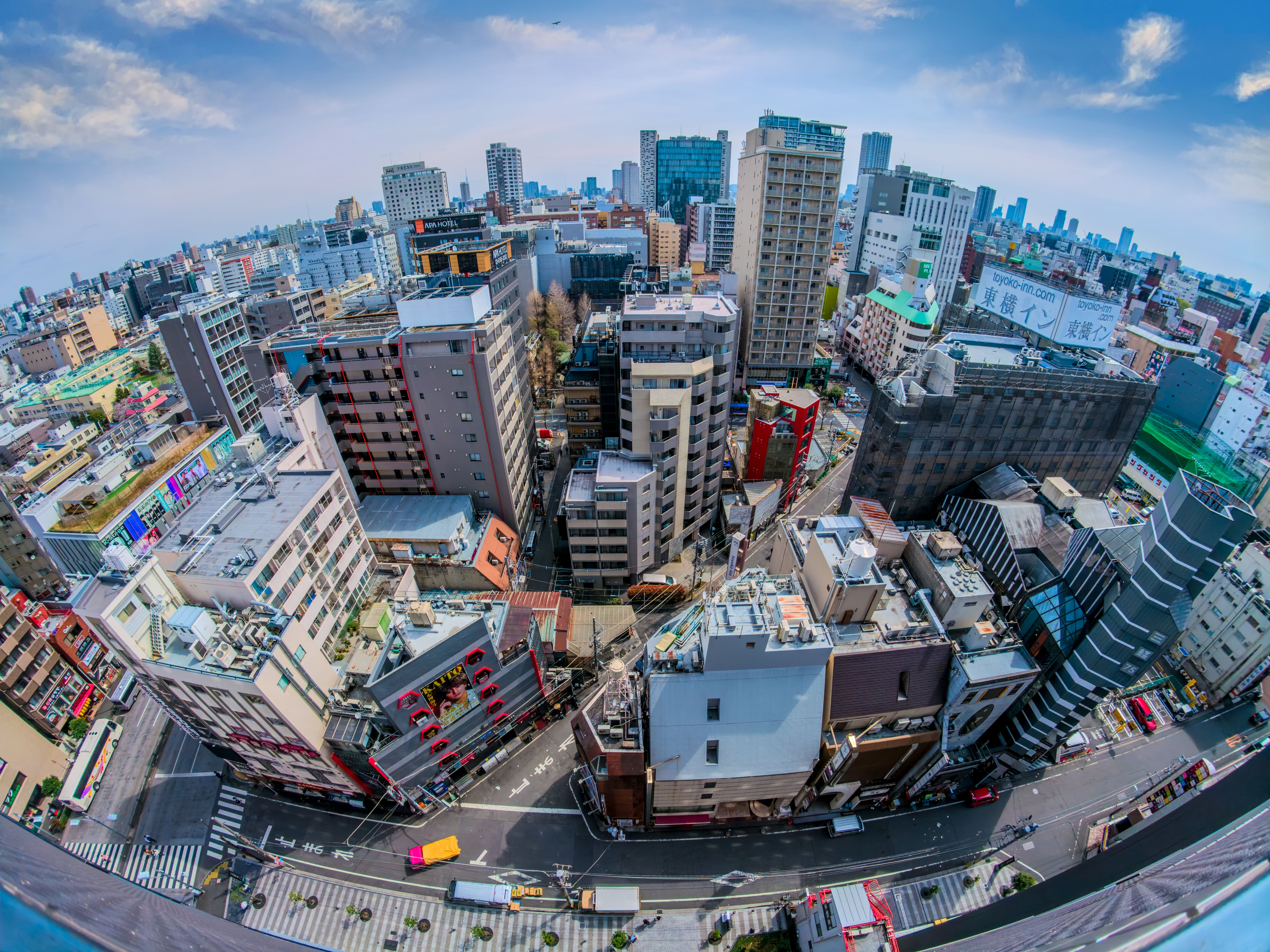 Aerial view of a vibrant Tokyo neighbourhoods skyline, similar as Higasji-Jujo, showcasing tall buildings and bustling streets below.